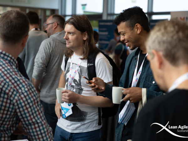 Conference participants gathered around, engaged in discussions
